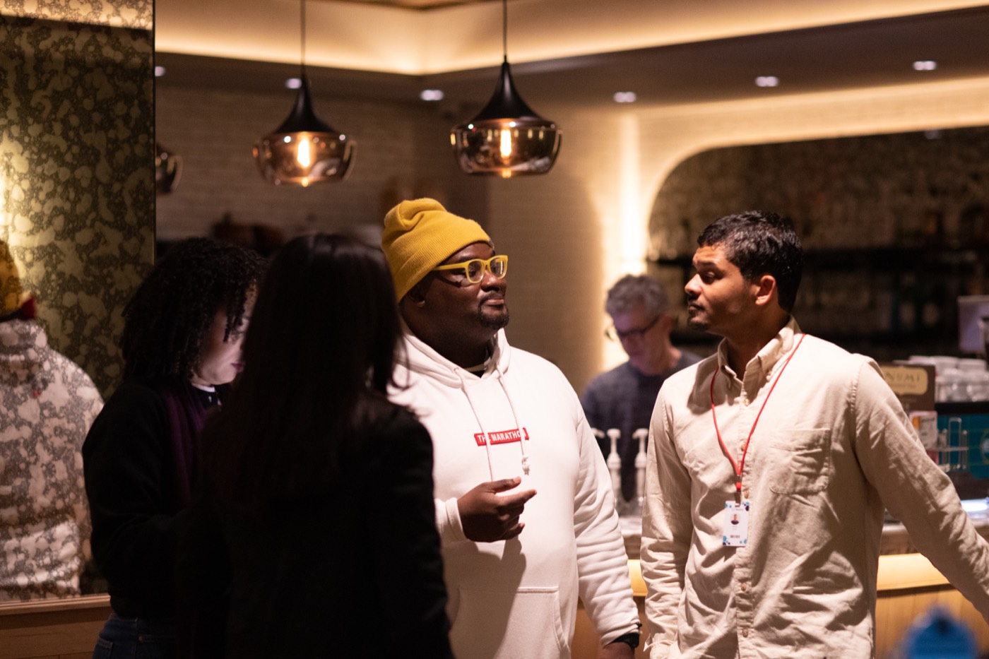 Behind-the-scenes image from Everything Is Fake showing the director in conversation with cast.